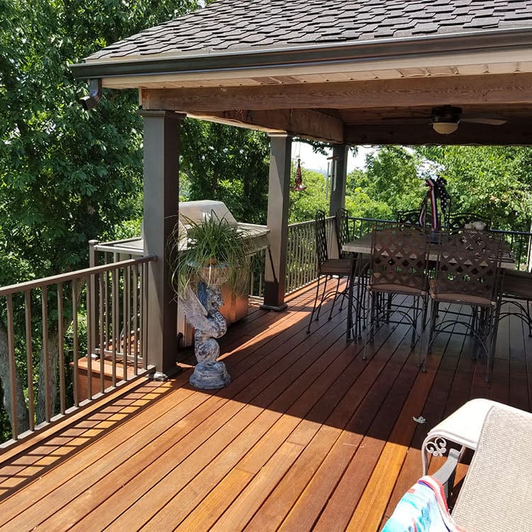 A wooden deck with a table and chairs.