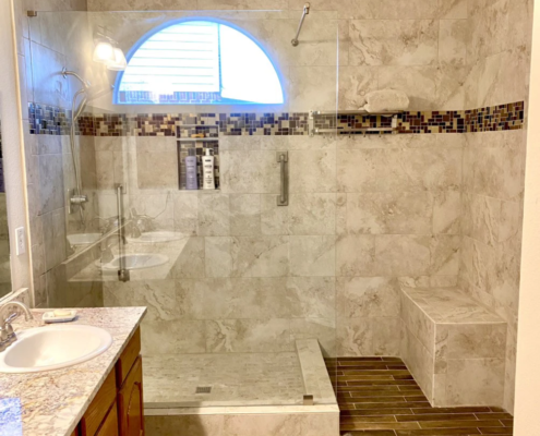 Bathroom remodeling with a walk-in shower and sink.