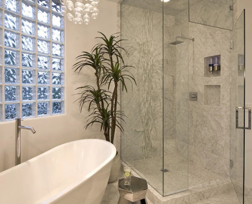 A luxurious bathroom with a bathtub and a chandelier, perfect for bathroom remodeling.