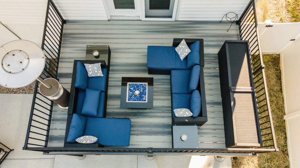 An aerial view of a deck with blue furniture.