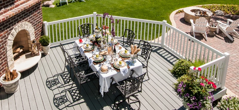 A Deck equipped with a table, chairs, and a fire pit.