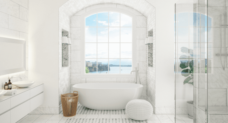 A super modern white bathroom with a stand alone soaker tub